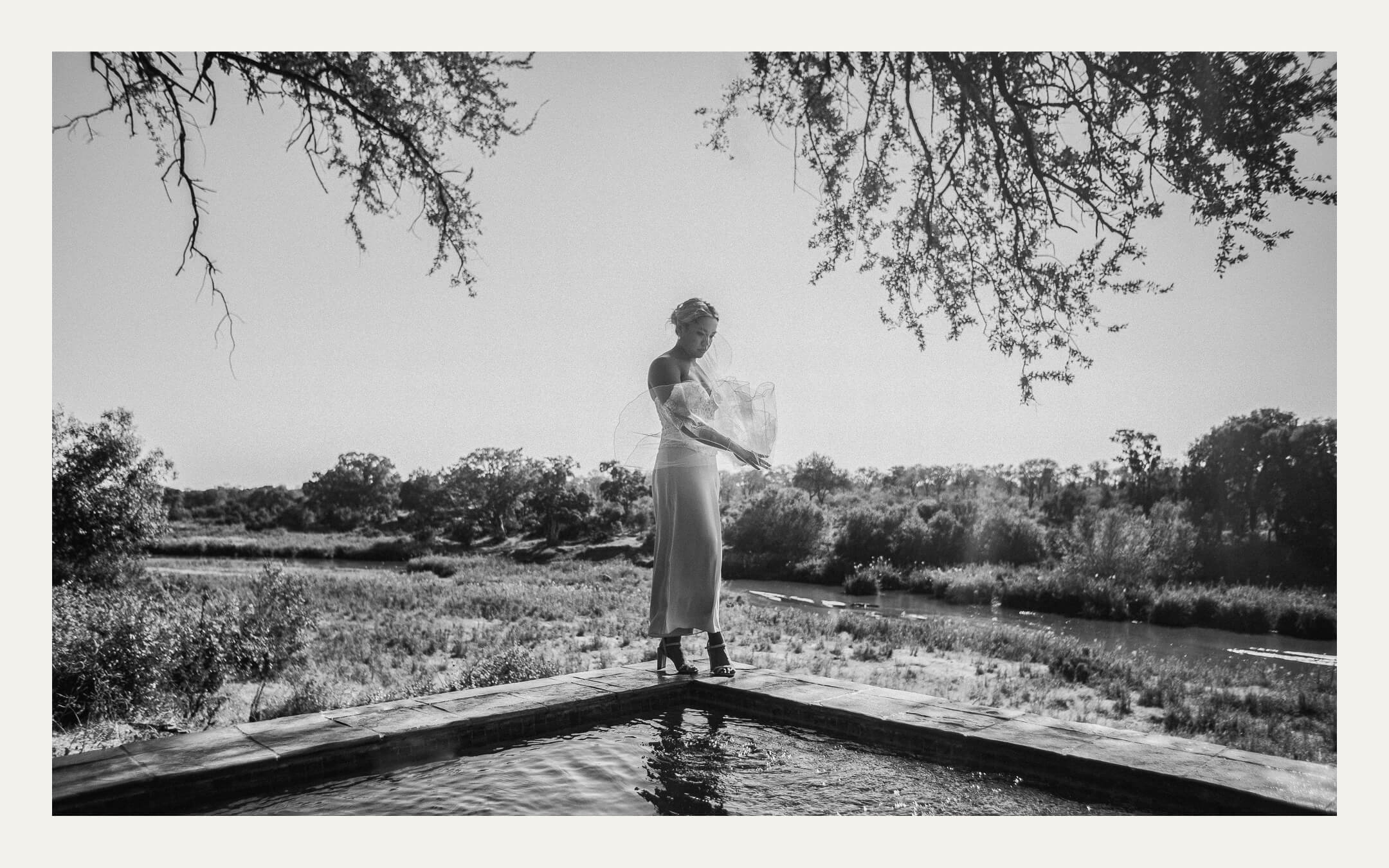 Bride reflected in a still pool — Ben Viljoen Photography