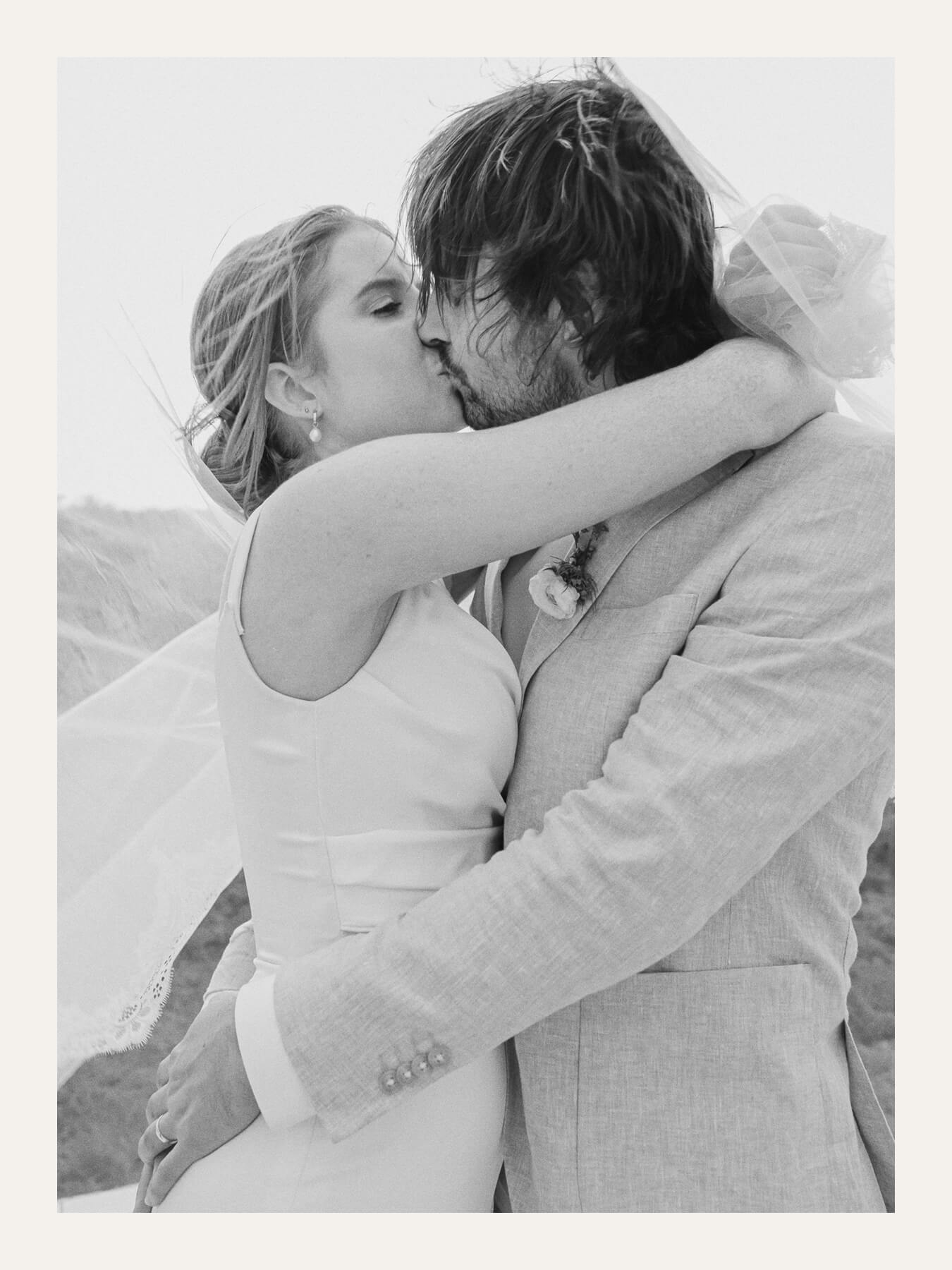 Bride and groom embracing under a veil. Ben Viljoen Photography