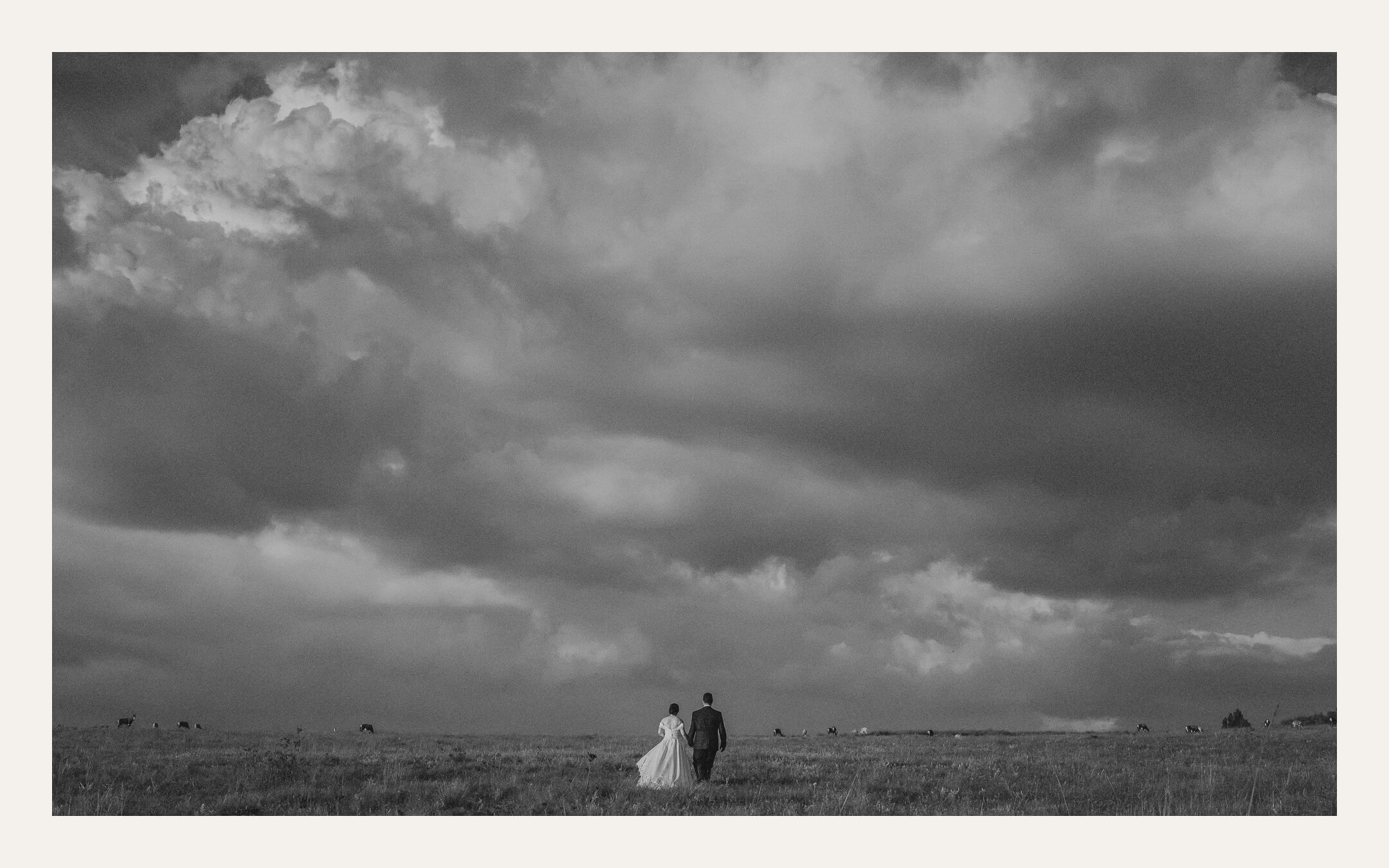 Dramatic clouds over a small couple in the landscape — Ben Viljoen Photography